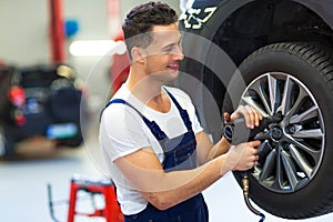 Car mechanic changing tires