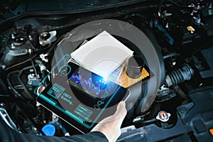 Car mechanic checking ECU electronic control unit with OBD or OBD2 wireless scanner tool photo