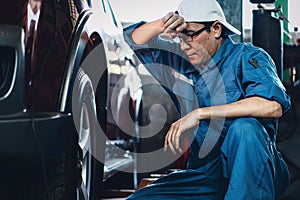 Car mechanic checking and repair customer car at garage and maitenance station