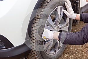 The car mechanic is engaged in repair of cars repair oil change change of wheels polishing of a body