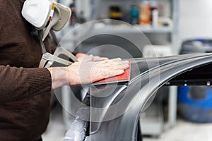 Car mechanic grinds a car part in handicraft in a service station - Serie car repair workshop