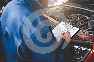 Car mechanic inspecting vehicle. Auto inspection concept