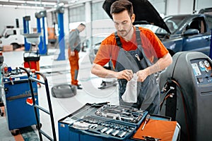Car mechanic keeping tools polished