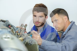 car mechanic man fixing engine at garage