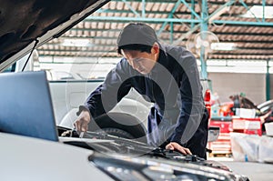 Car mechanic in repair garage, Technician man working in auto repair shop, Car repair and maintenance concepts