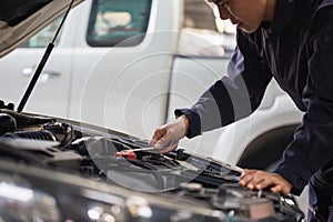 Car mechanic in repair garage, Technician man working in auto repair shop, Car repair and maintenance concepts