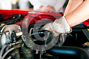 Car mechanic in repair shop