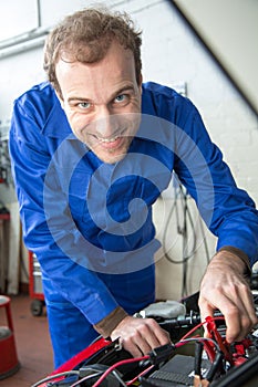 Car mechanic repairing a automobile