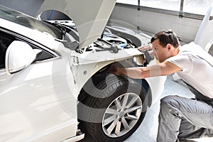 Car mechanic repairs car bodywork of a vehicle after a traffic a photo