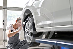 Car mechanic repairs car bodywork of a vehicle after a traffic a