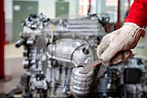A car mechanic repairs an engine in a car service. photo