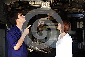 Car mechanic talking to costumer photo