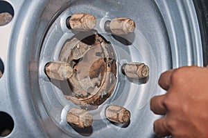 Car Mechanic Tighten Car Wheel Nut to Wheel Bolt