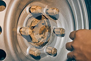 Car Mechanic Tighten Car Wheel Nut to Wheel Bolt in Vintage Tone