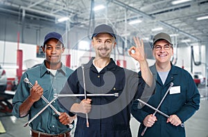 Car mechanic with tire wrench.