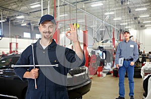 Car mechanic with tire wrench.