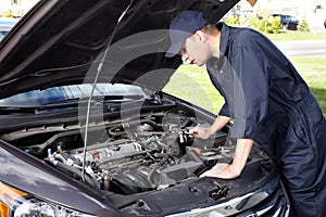 Car mechanic working in auto repair service.