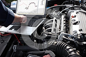 Car mechanic working in auto repair service. photo