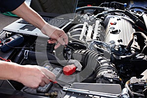 Car mechanic working in auto repair service. photo