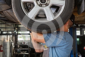 Car mechanic working in auto repair shop