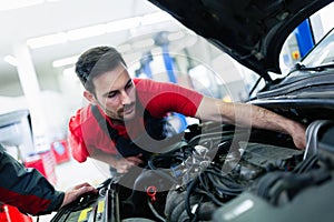 Car mechanic working at automotive service center