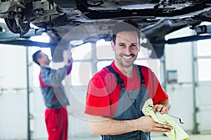 Car mechanic working at automotive service center