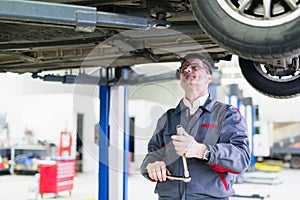 Car mechanic working at automotive service center