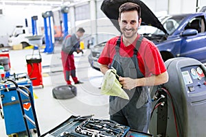 Car mechanic working at automotive service center