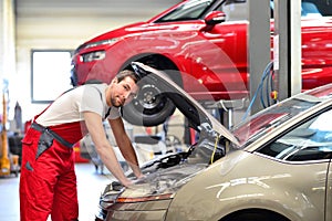 car mechanic in a workshop repairing a vehicle