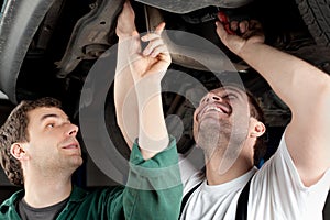 Car Mechanics repairing car photo