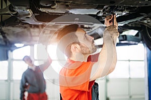 Car mechanics working at automotive service center