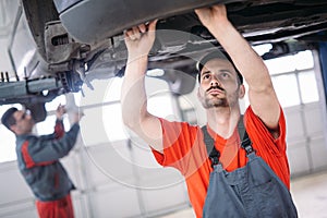 Car mechanics working at automotive service center