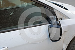 Car mirror broken off, consequences of a car accident. Damage to a car sedan, vandalism, hooliganism, car damage. Torn right side photo