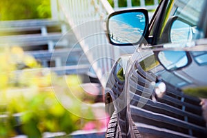 Car mirror. Reflection of sunny blue sky at the car side mirrow.