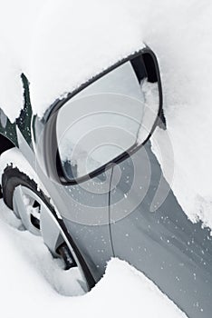 Car mirror in snow
