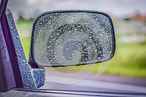 CAR Mirror Window glass ON THE GO -TRAVELLING with condensation of natural water drops. Abstract photo