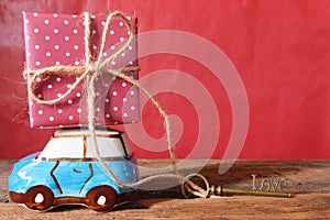 A car model carrying a gift box and love shape key, delivering love. Happy Valentine's day concept