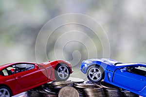 Car model on money coins pile. Finance and car loan, saving money for a car, coins insurance, loan and buying car finance concept