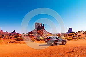 Car on the Monument Valley drive. The Valley Drive is a scenic dirt road through Navajo Tribal Park between Arizona and Utah.