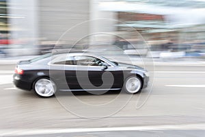 Car in motion blur, car driving fast in city