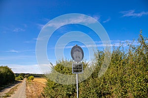 Car and Motorcycle Forbidden Sign on a dirt road, with blue sky