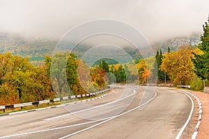 car mountain road in the autumn Crimea, low clouds