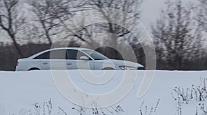 Car moves in the winter on a snowy road