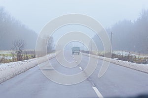 A car moving ahead on the road in winter