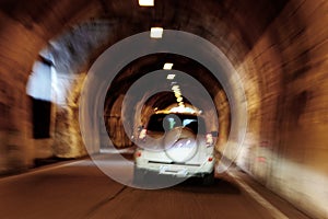 The car is moving rapidly through the tunnel. unsharply blurred