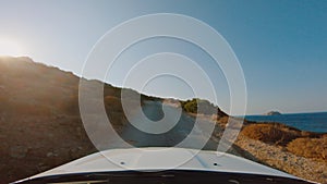 Car moving small country road, driving on mountain road near Aegean coast