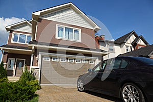 Car near garage of new two-storied cottage