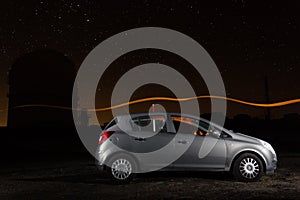 Car and observatory under the stars