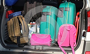 Car overloaded with suitcases and duffle bag