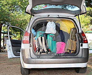 Car overloaded with suitcases for travel